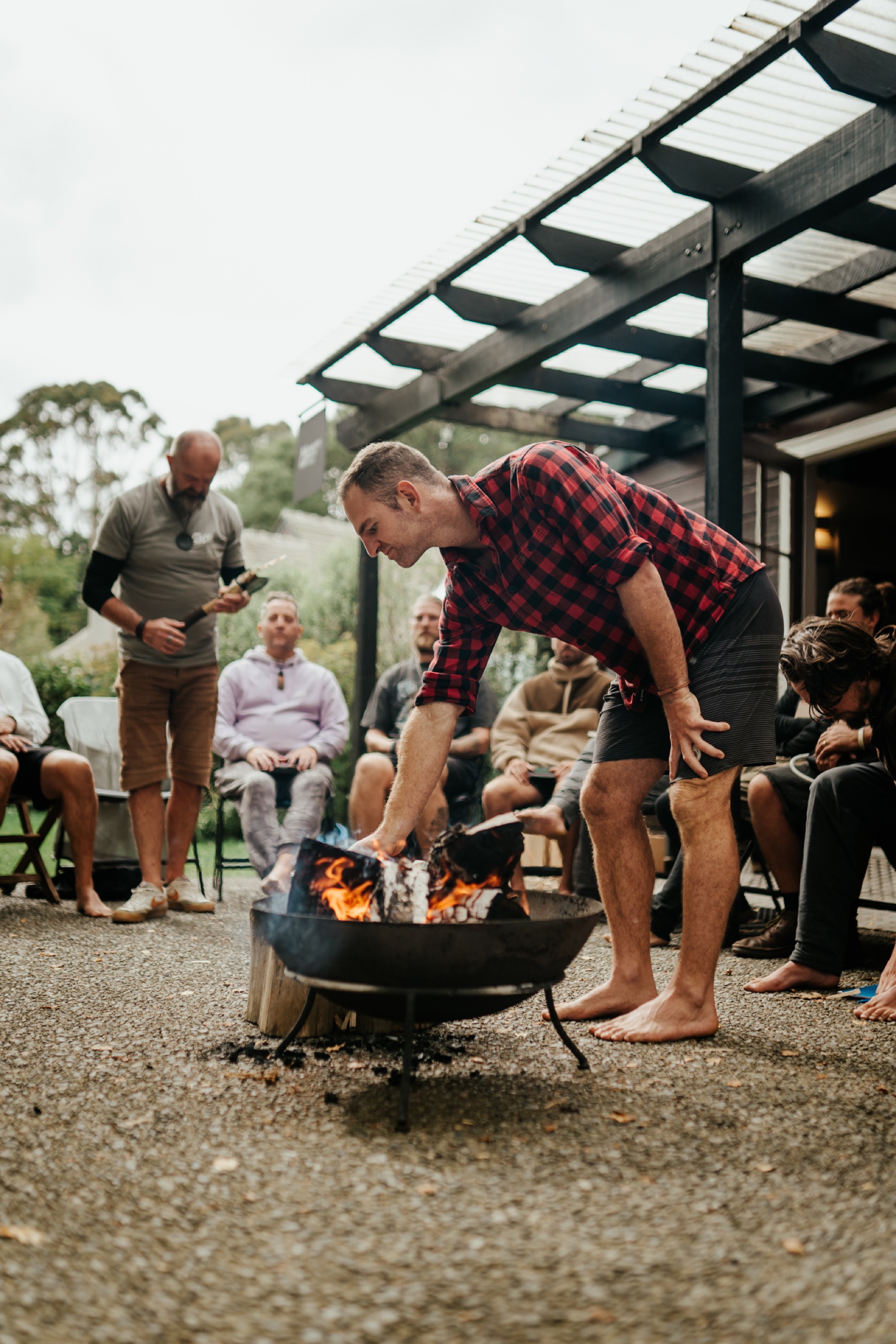 Man tending fire at BROS retreat